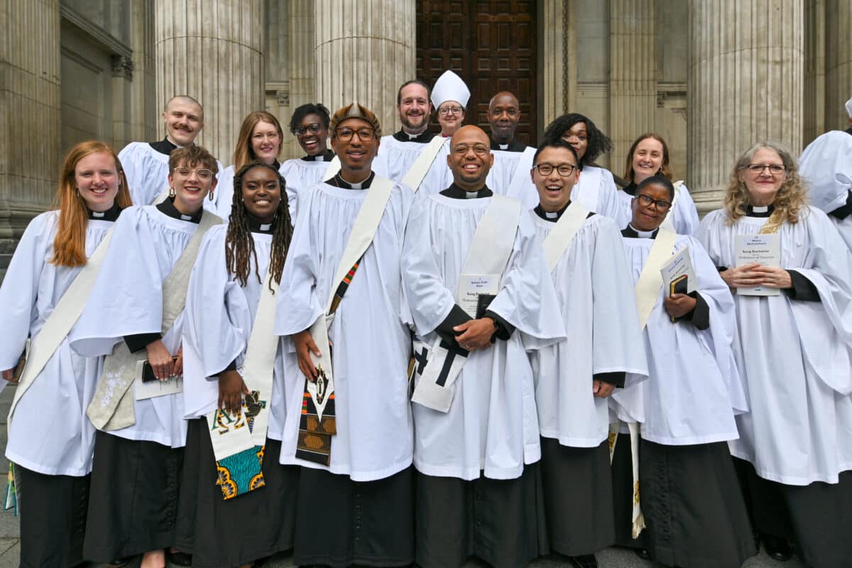 Image of smiling clergy on the steps of St Paul's cathedral