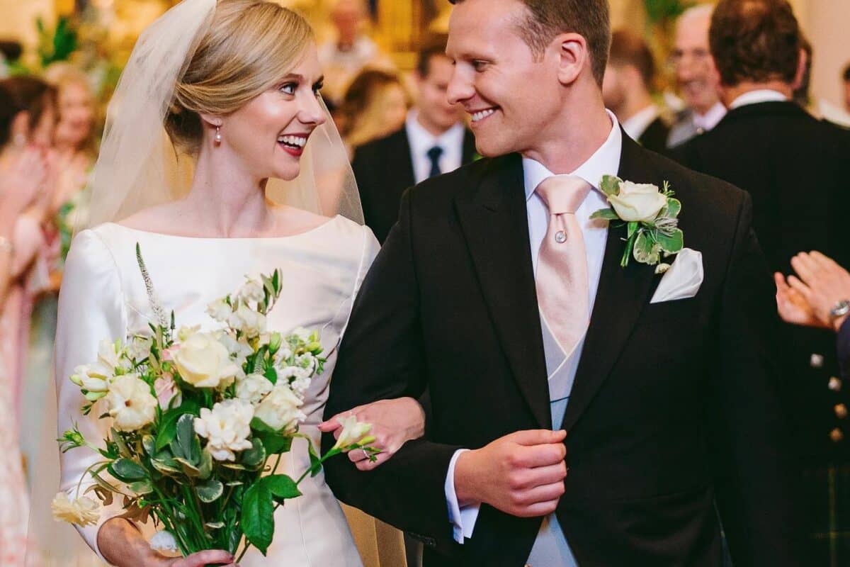 Image of bride and groom walking down the aisle