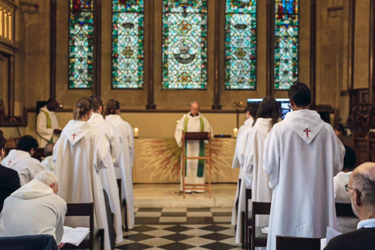 St Anselm Community in white robes worshipping