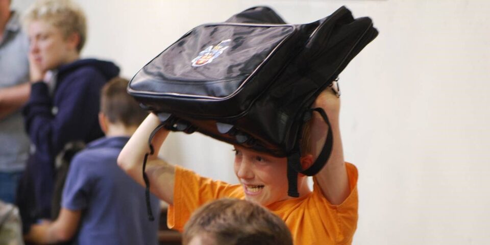 Young people enjoy having their back packs blessed.