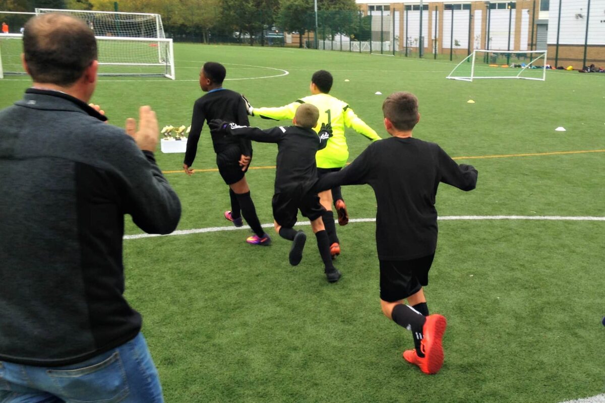 Children playing football outside