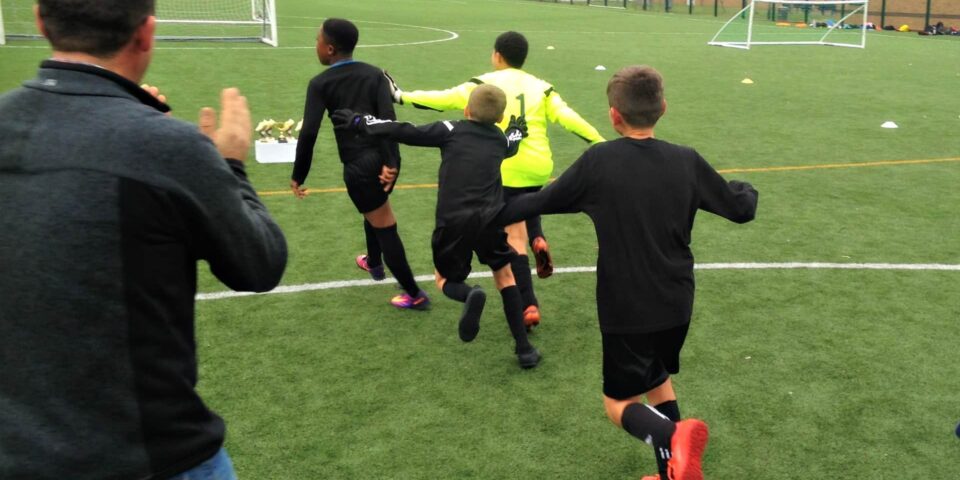 Children playing football outside