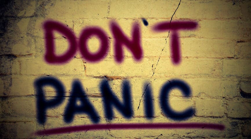 The words Don't panic, written on a wall