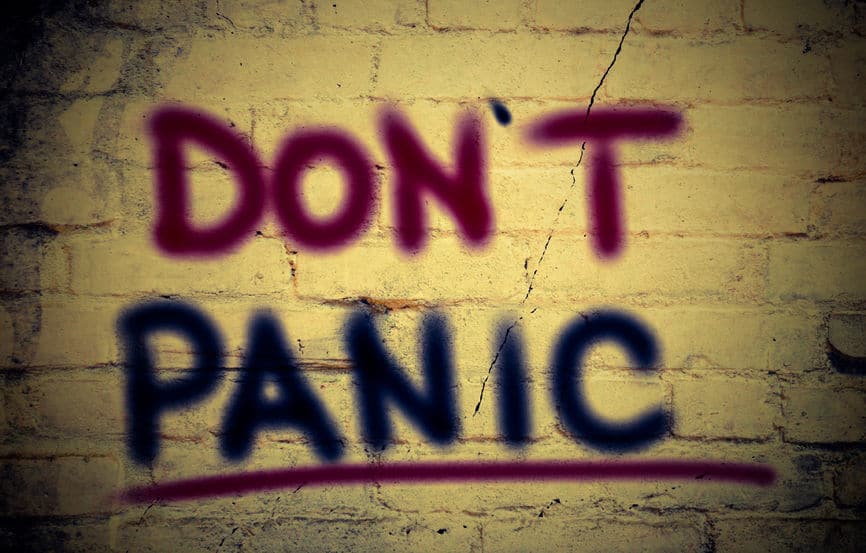 The words Don't panic, written on a wall