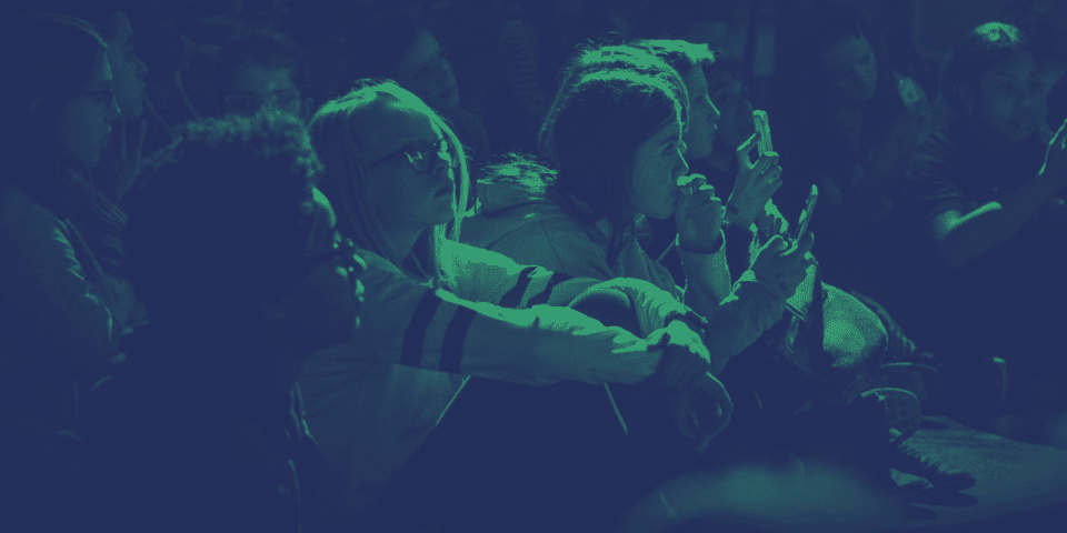 Young people sitting down listening