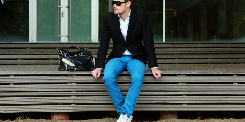 Young man sporting a black jacket and sunglasses