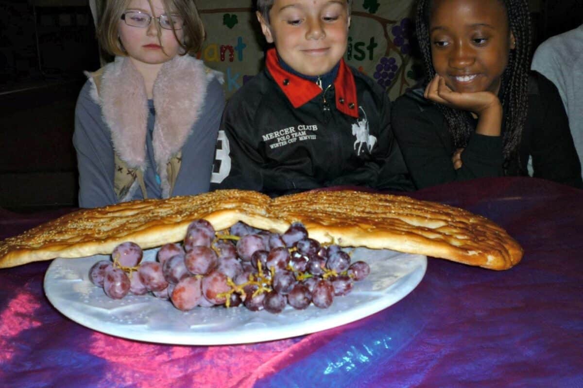 Three children eyeing up a banquet