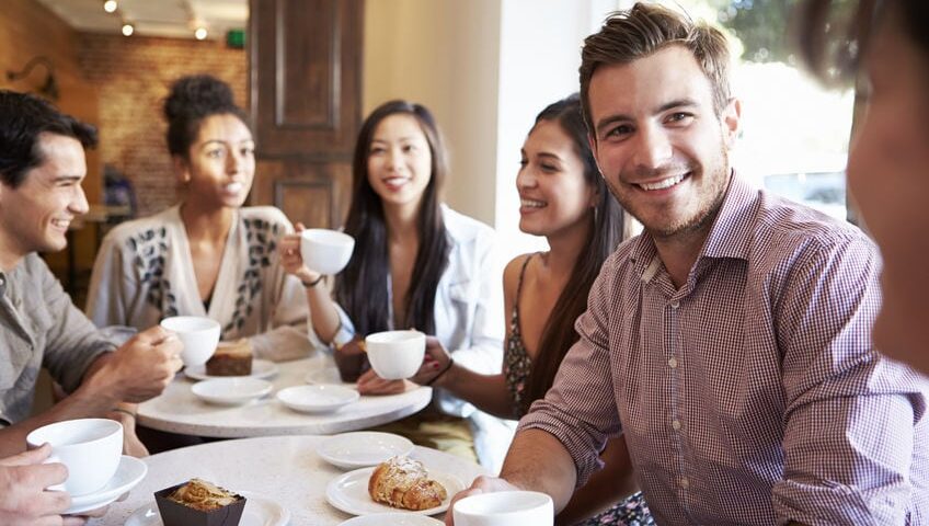 Young people in a coffee shop looking really happy. Probably not like real children's workers look, but we found this stock photo amusing