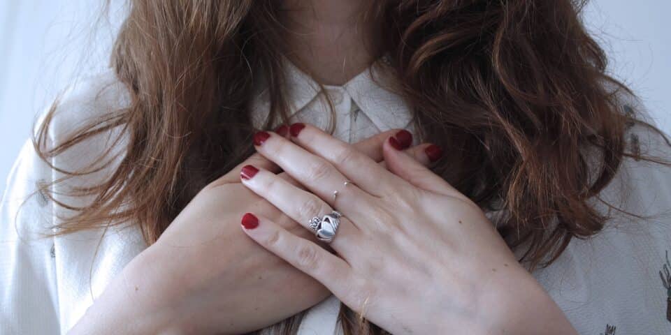 woman with hands on chest practising gratitude