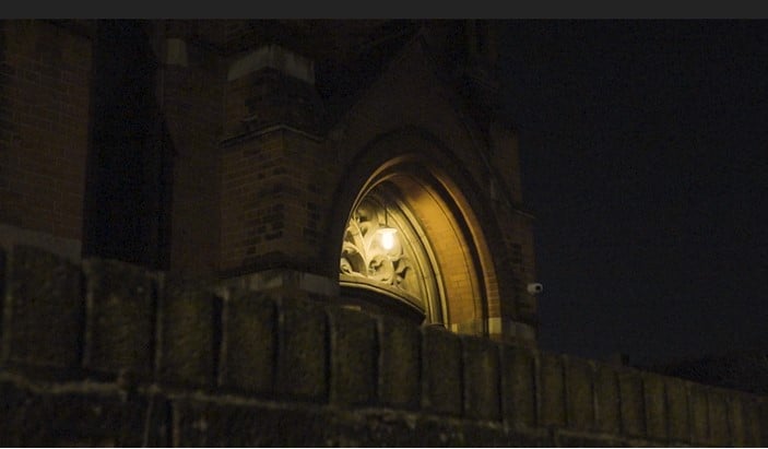 Church porch light shining at night.
