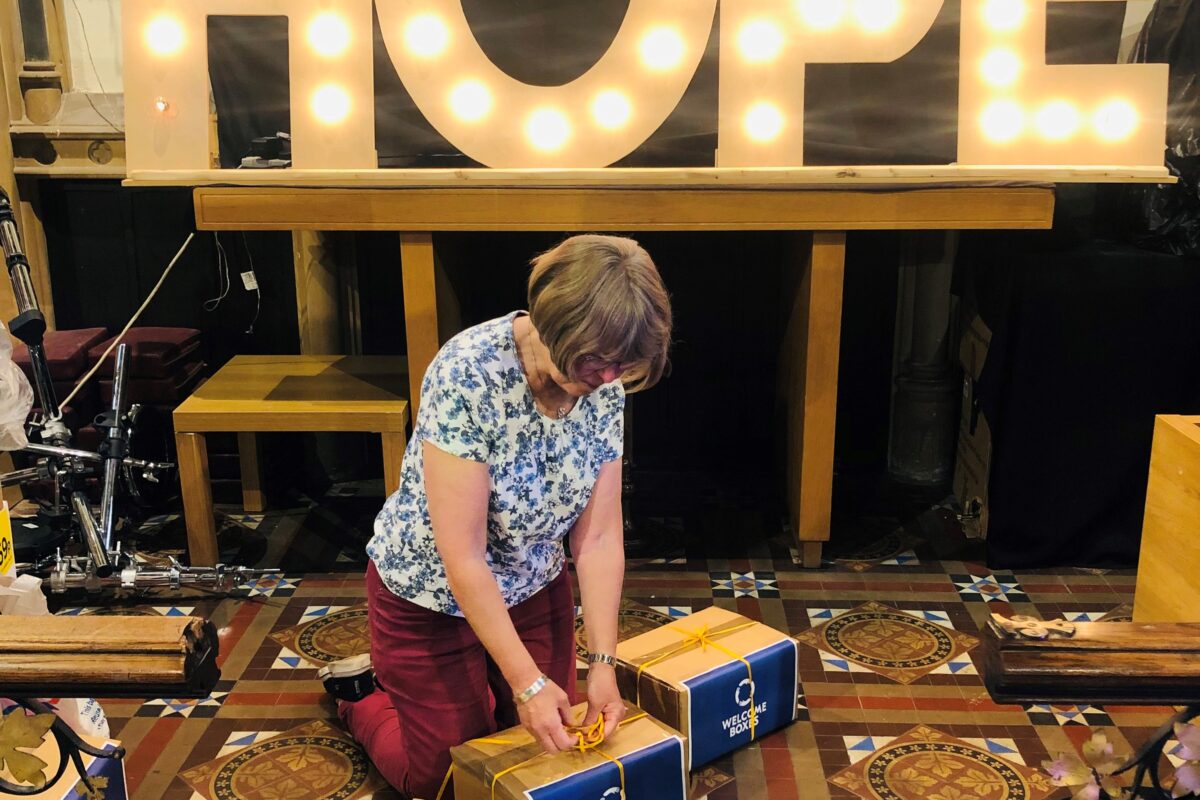 Woman packing welcome boxes.