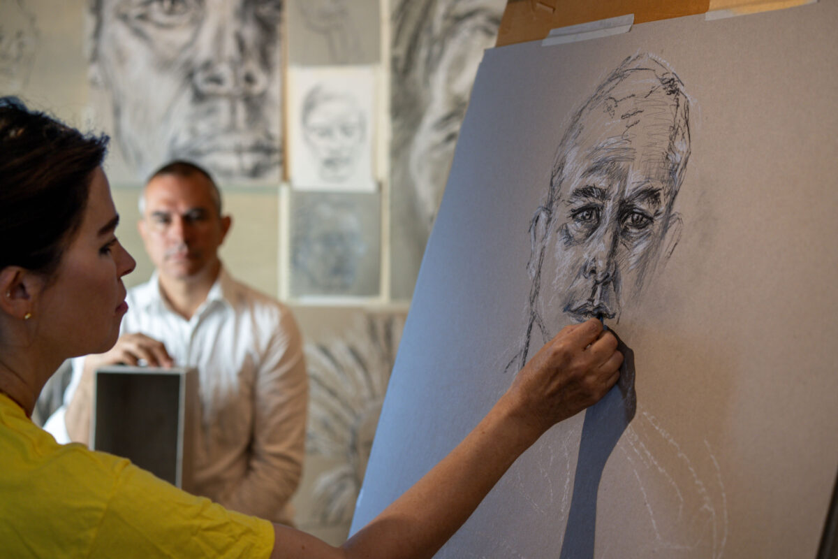 Es Devlin drawing a chalk portrait