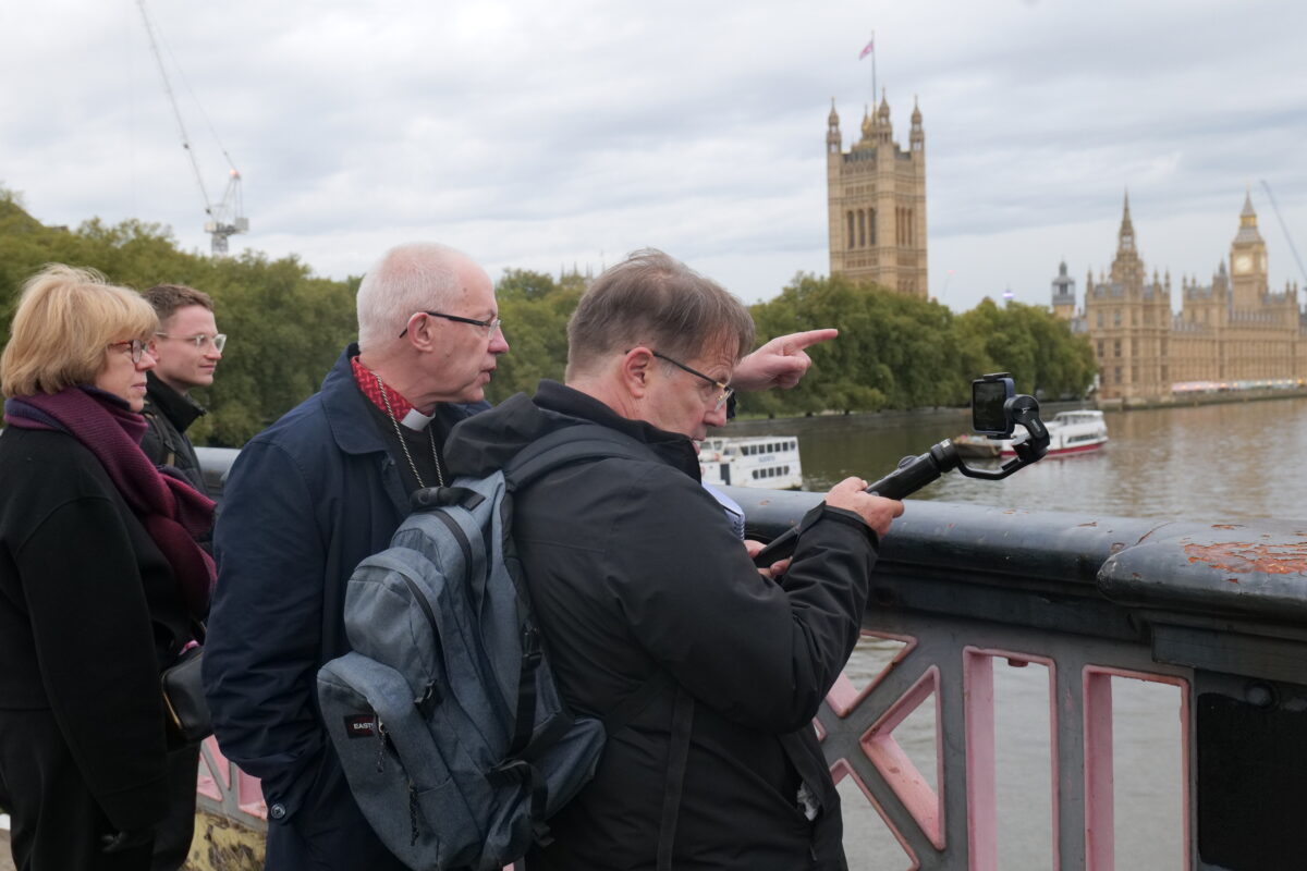 Archbishop Justin and the Revd Richard Carter on a bridge with parliament in the backgroud