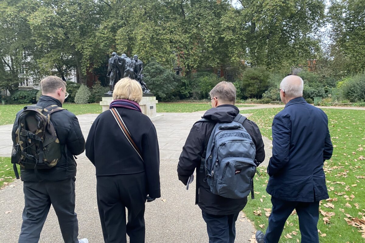 Bishop Sarah, Archbishop Justin, and the Revd Richard Carter walking through a park