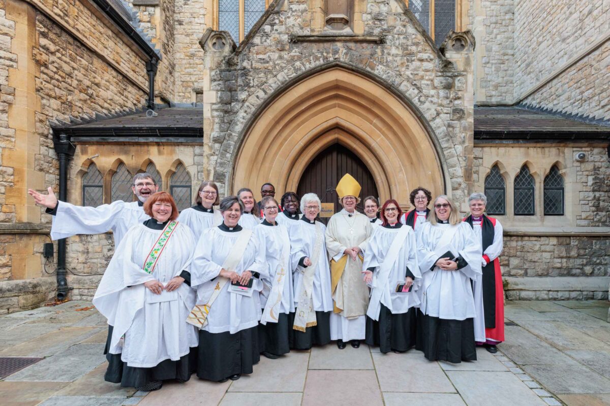 New deacons outside the church door smiling and cheering