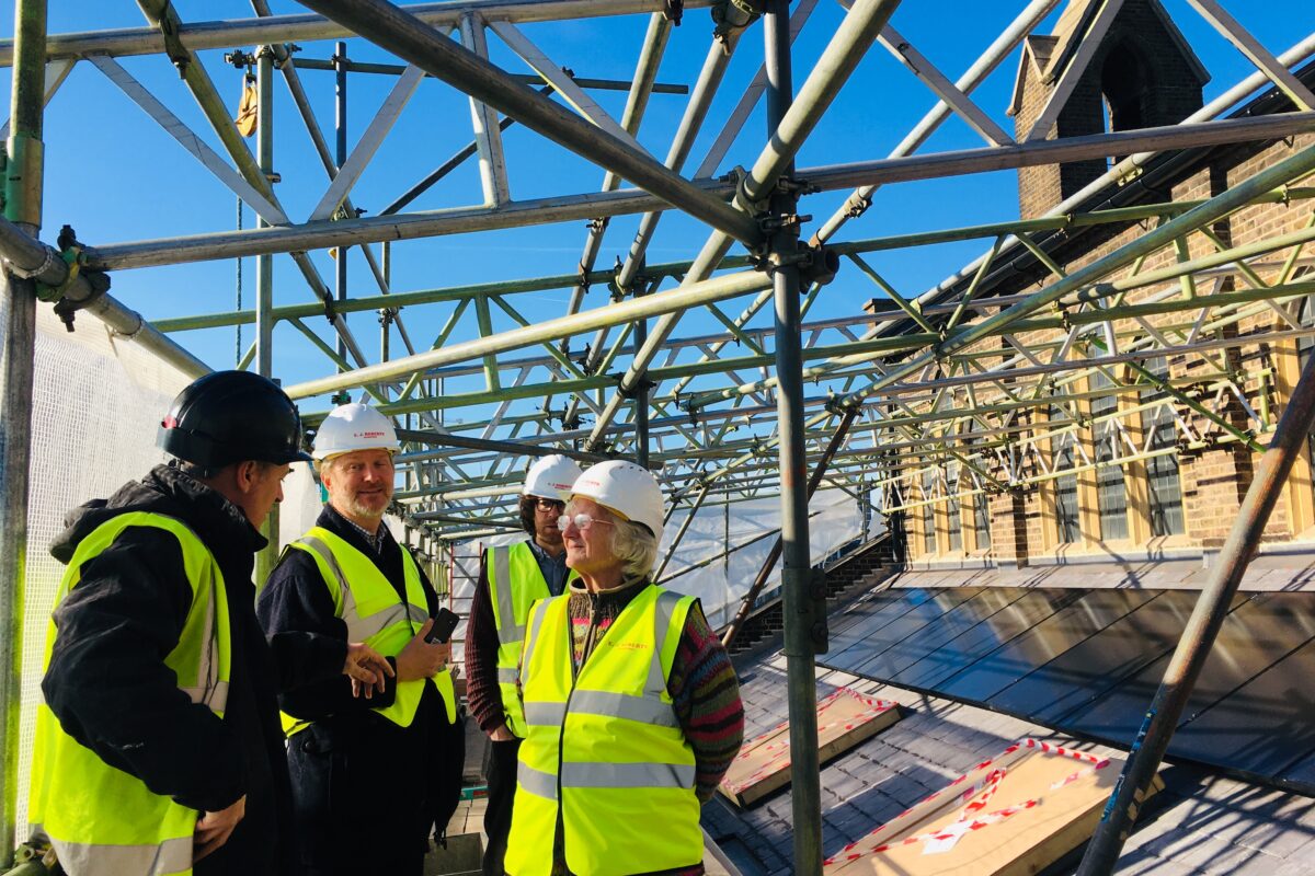Scaffolding on top of St paul's Marylebone - a gathering of people with hard hats and high vis jackets