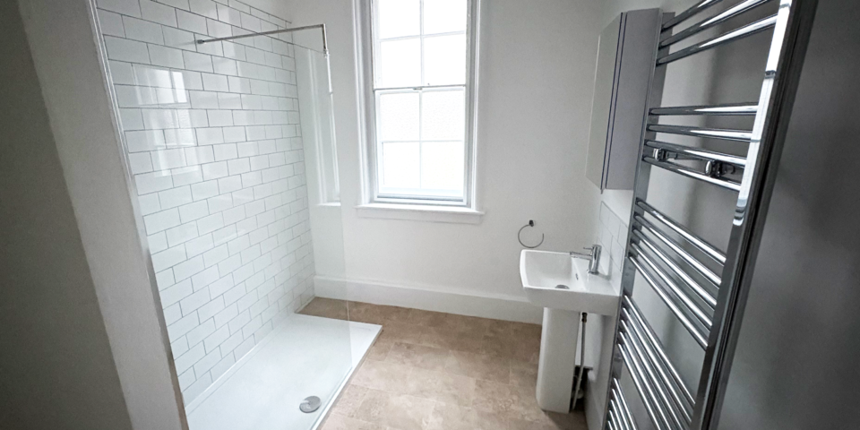 Bathroom with white tiles and shower