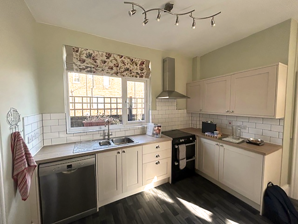 Clergy kitchen with white wooden cupboards