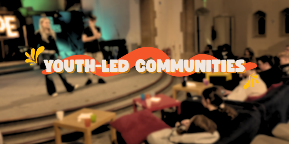 Blurred image of a youth group with the words 'youth-led communities'