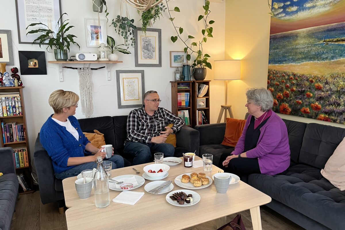 Bishop Emma chatting to Jeannine and Stephan who manage the house.