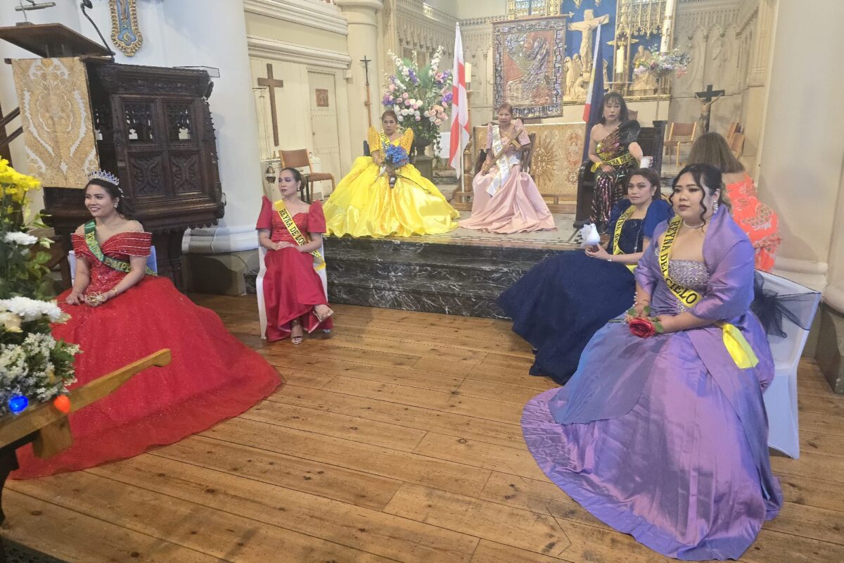 Women in colourful dresses sitting at the front of the church