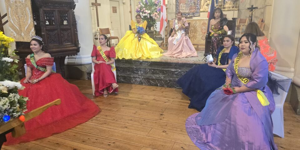 Women in colourful dresses sitting at the front of the church