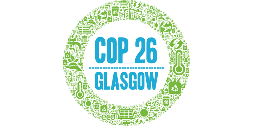 The words COP26 over the word Glasgow surrounded by a green band