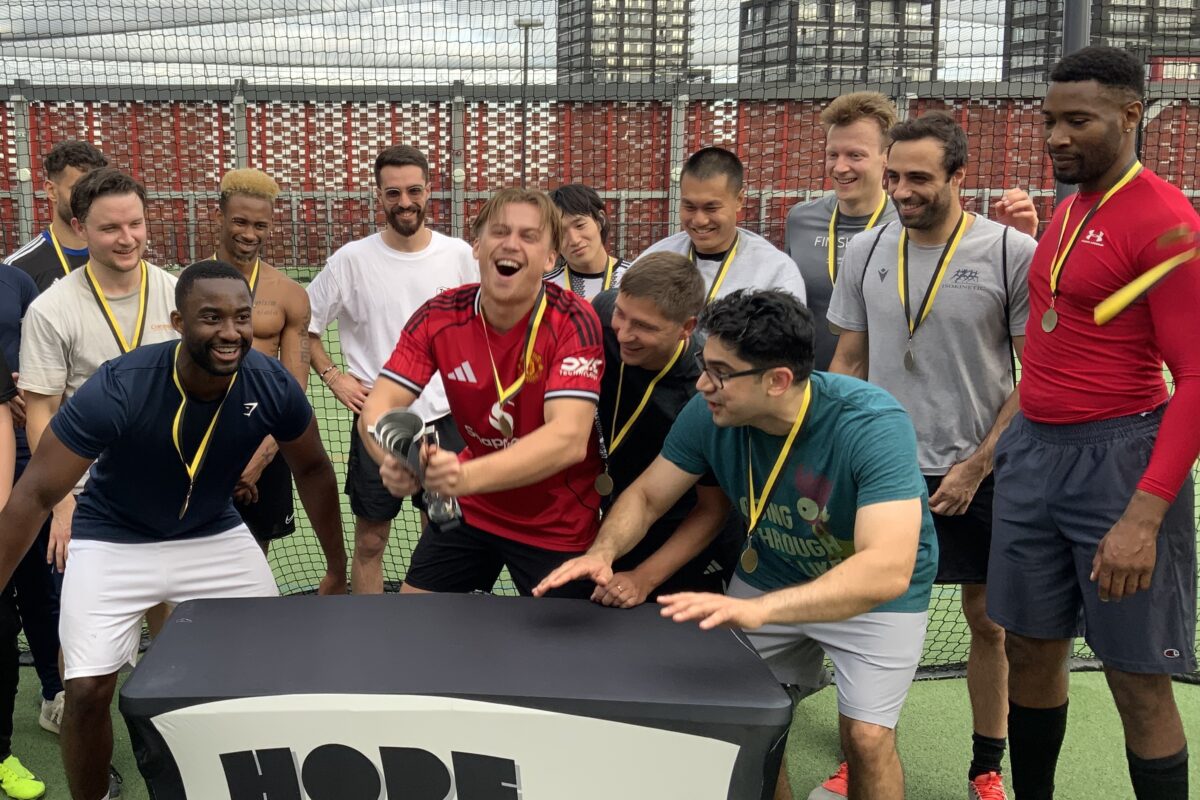 A group of footballers, with a 'Hope Street' sign