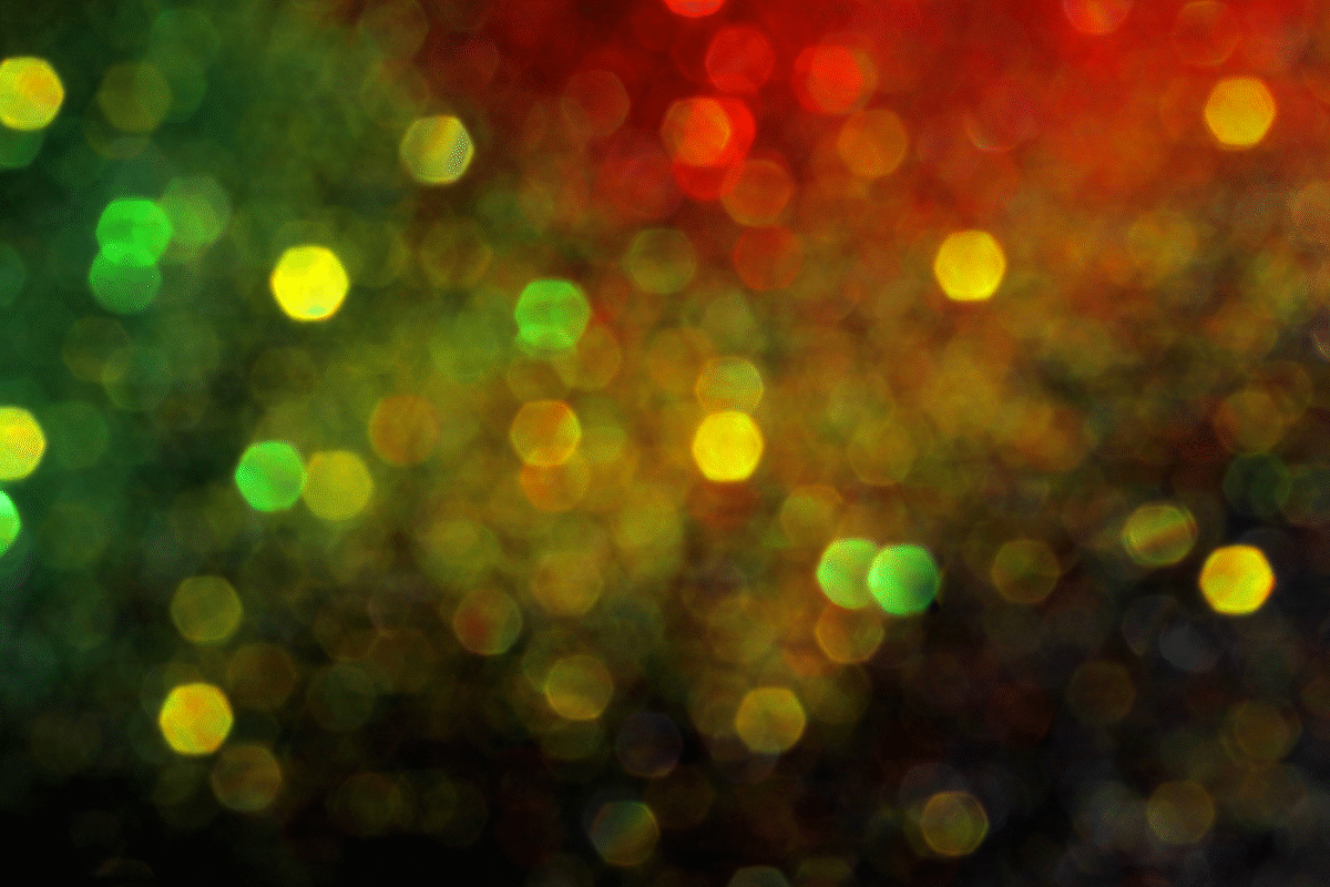 Abstract image of people of holding candles at a Black History Month event.