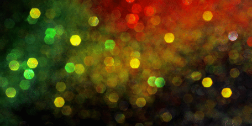 Abstract image of people of holding candles at a Black History Month event.