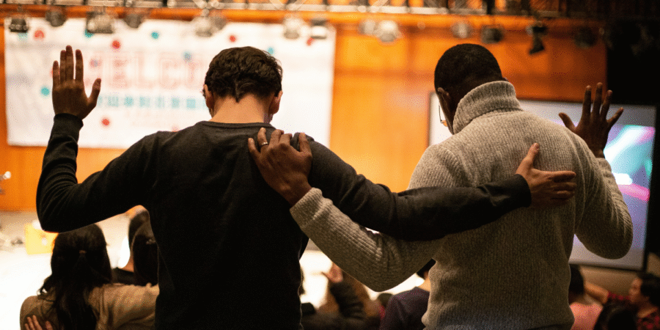 Two young men in a diverse church