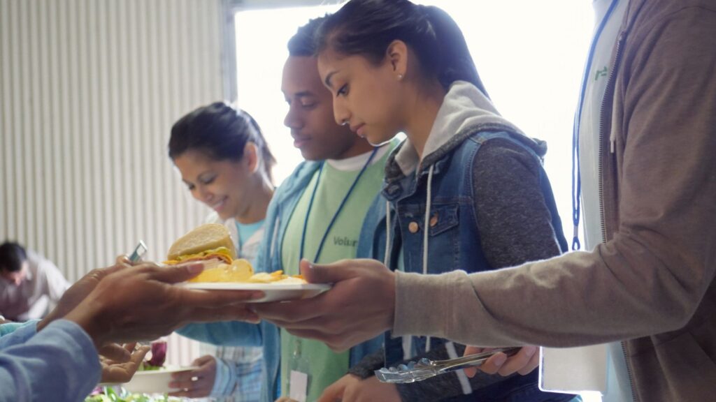 Food is served at a social action project supported by the Cinnamon Network.