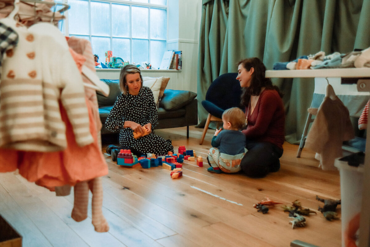A Choices staff member puts out toy blocks for a mum and baby in the KXC Boutique.